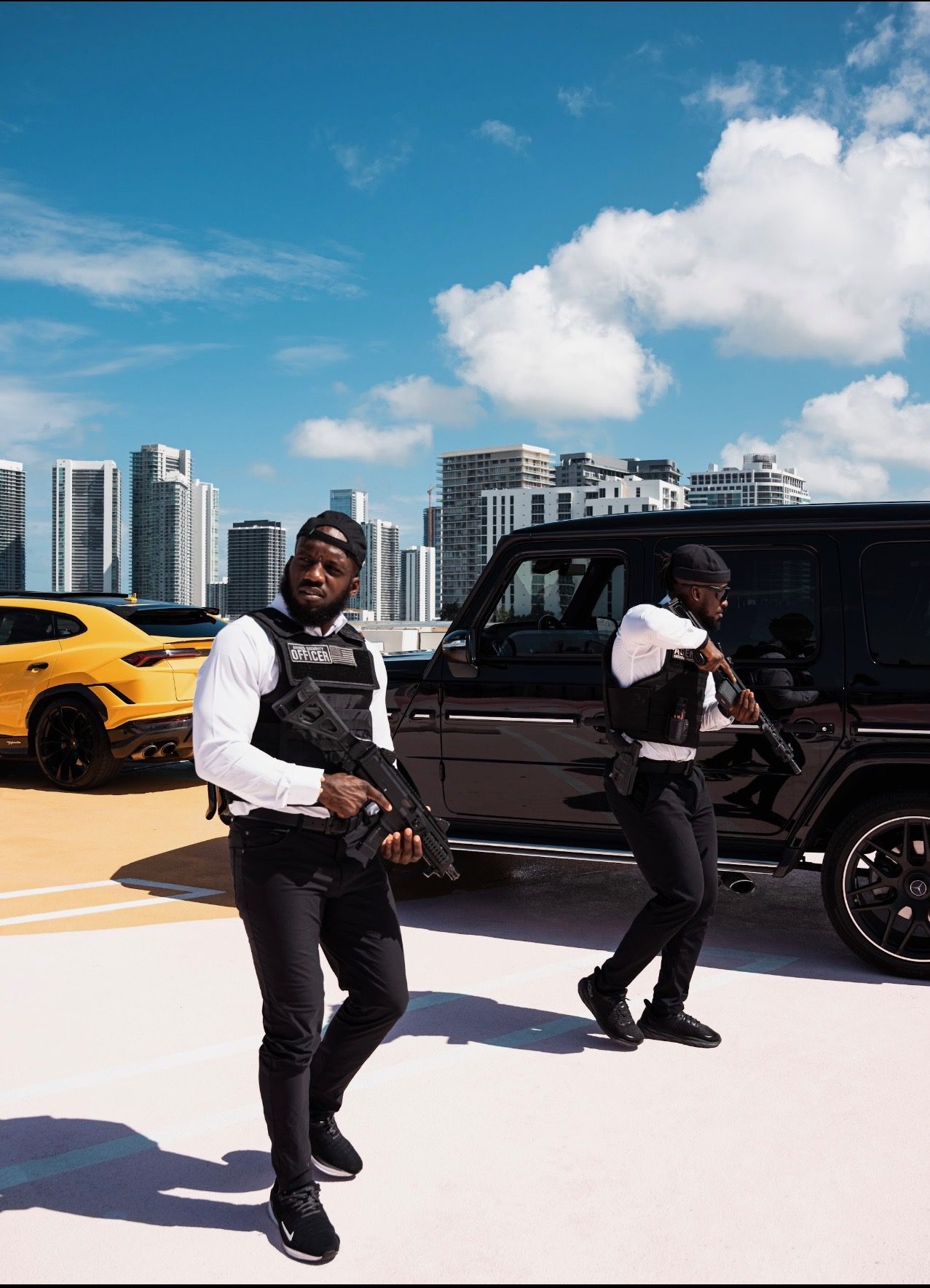 Armed Spectrum agent with a black G-Wagon and supercar against the Miami skyline